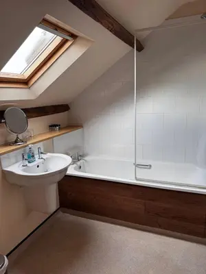 a bathroom with a sink and a bath tub at Ecclefechan Hotel in Ecclefechan