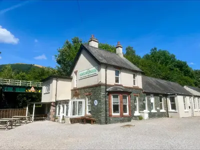a building with a sign on the side of it at Denton House Hostel in Keswick