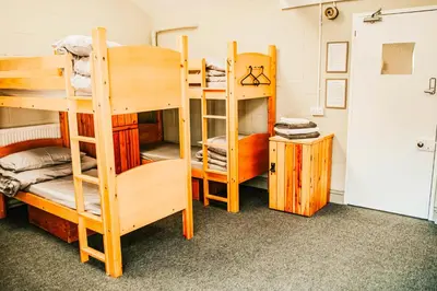 a room with several bunk beds in it at Denton House Hostel in Keswick