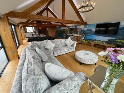 a living room with a couch and a table at Blencathra Barn in Penrith