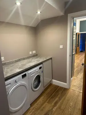 a laundry room with a washing machine in it at Cumberland House in Cockermouth