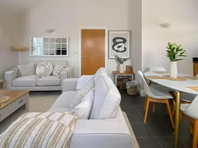 a living room with a white couch and a table at The Guards Quarters - Uk47594 in Silloth