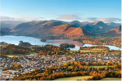 an aerial view of a city with a lake and mountains at Tranquil House with Sea Views in Parton