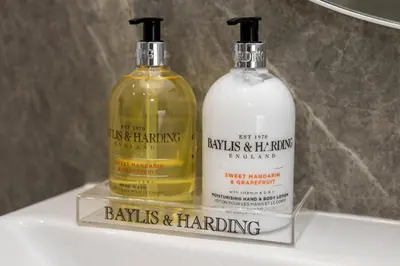 two bottles of alcohol sitting on top of a shelf at Tranquil House with Sea Views in Parton