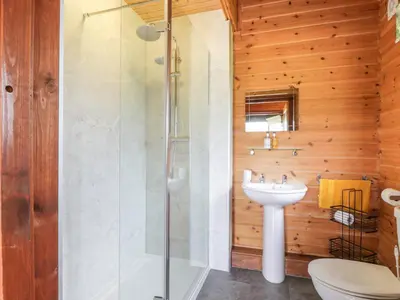 a bathroom with a shower and a sink at Glenisle in Dalbeattie