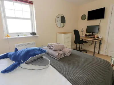 a bedroom with a stuffed shark on a bed at Ptarmigan in Newton Stewart