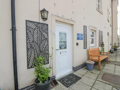 a door to a building with a bench next to it at Ptarmigan in Newton Stewart