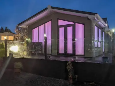 a tiny house with pink lights on it at Zion's Retreat in Plumbland