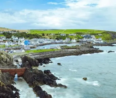 a view of a beach with houses and the ocean at Doonhill in Portpatrick in Portpatrick