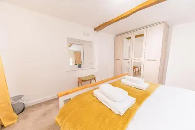 a bedroom with a bed with two towels on it at 4BR Holiday Home Steps from Keswick Town Centre in Keswick