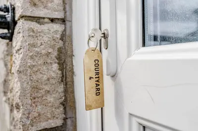 a key chain with a tag on a door at Auchenlarie Courtyard No 4 in Gatehouse of Fleet
