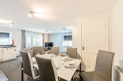 a dining room with a table and chairs at Auchenlarie Courtyard No 2 in Gatehouse of Fleet