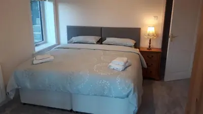 a bedroom with a bed with two towels on it at Braesyde in Kippford