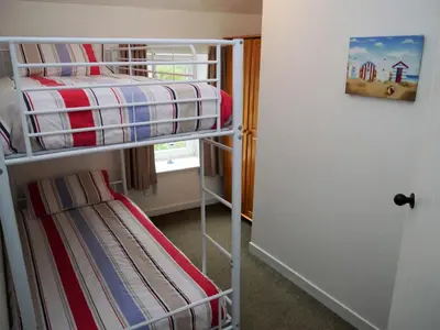 a couple of bunk beds in a small room at Swallow Cottage in Dalbeattie