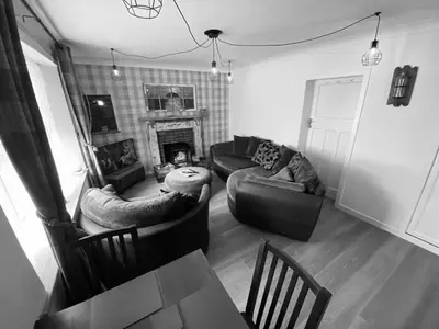 a living room with a couch and a fireplace at Shore Cottage in Girvan