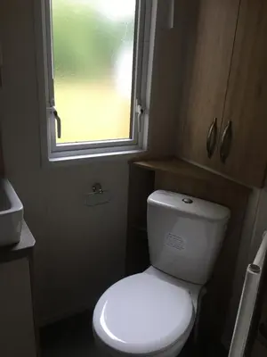 a small bathroom with a toilet and a window at Carlisle CAMELOT HOLIDAY PARK CA65SZ Blenheim in Longtown