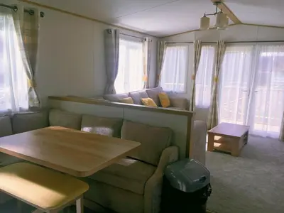 a living room with a couch and a table at Carlisle CAMELOT HOLIDAY PARK CA65SZ Blenheim in Longtown