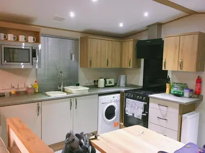a kitchen with a washer and dryer in it at Carlisle CAMELOT HOLIDAY PARK CA65SZ Blenheim in Longtown