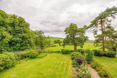 an aerial view of a garden with trees and bushes at Bellrigg in Castle Douglas