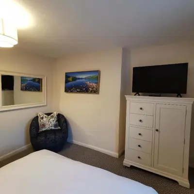 a bedroom with a bed and a flat screen tv at The Swinside Inn in Keswick