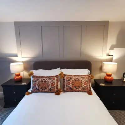a bedroom with a bed with pillows and two lamps at The Swinside Inn in Keswick