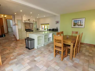 a large kitchen with a wooden table and chairs at Gallery Cloisters in Keswick