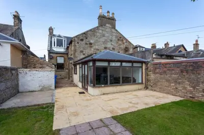 an extension to a brick house with a conservatory at St Meddans Mews in Troon in Troon