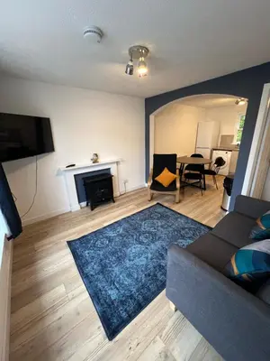 a living room with a couch and a fireplace at The Ship Inn's Cabin in Gatehouse of Fleet