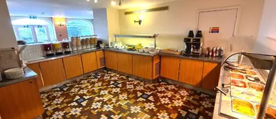 a kitchen with a counter with a lot of food at The Empress Hotel in Douglas