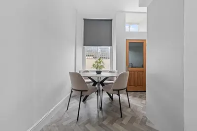 a dining room with a table and chairs at The Manor - Beachwalk Apartments in Ayr