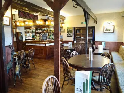 a restaurant with tables and chairs and a bar at Room with Newly Renovated Private Bathroom above Village Pub Stag Inn Crosby Maryport in Maryport