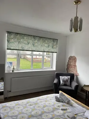 a bedroom with a bed and a window and a chair at Room with Newly Renovated Private Bathroom above Village Pub Stag Inn Crosby Maryport in Maryport