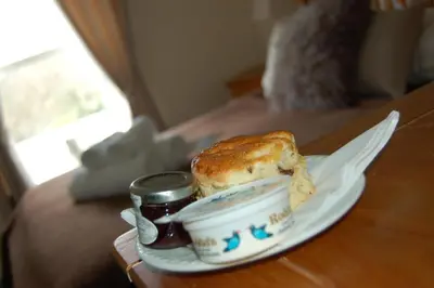 a sandwich and jam on a plate on a table at The Boot Inn in Boot