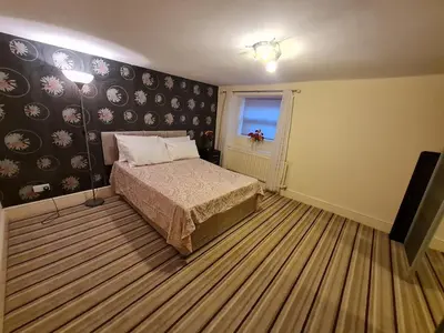 a small bedroom with a bed and a window at Douglas Head Road in Douglas