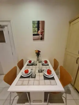 a white table with chairs and tomatoes on it at Douglas Head Road in Douglas