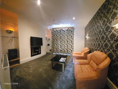 a living room with a couch and a television at Douglas Head Road in Douglas