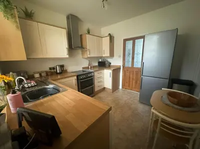 a kitchen with a sink and a refrigerator at Lonsdale Terrace - 3 Bedrooms - Sleeps 6 in Workington