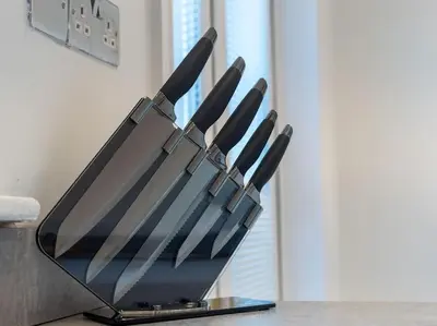 a group of knives in a knife block on a counter at Modern & Stylish 2 Bed Home in Whitehaven in Whitehaven