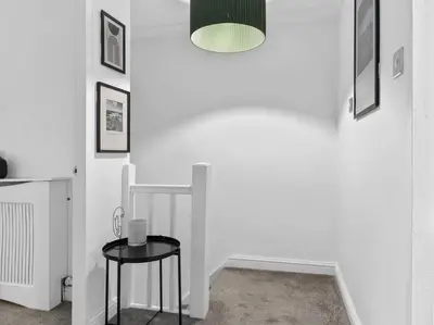 a white room with two tables and a lamp at Modern & Stylish 2 Bed Home in Whitehaven in Whitehaven