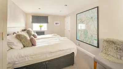 a bedroom with a large bed and a map on the wall at Derwentwater View in Portinscale