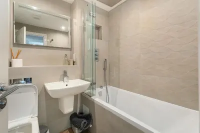 a bathroom with a sink and a bath tub and a sink at Derwentwater View in Portinscale