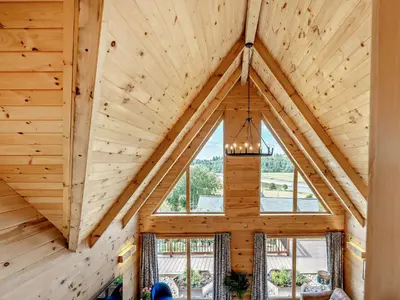 an attic with a large window in a log cabin at 4 Bed in Kippford 95234 in Kippford