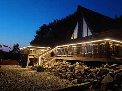 a house with lights on the side of it at 4 Bed in Kippford 95234 in Kippford