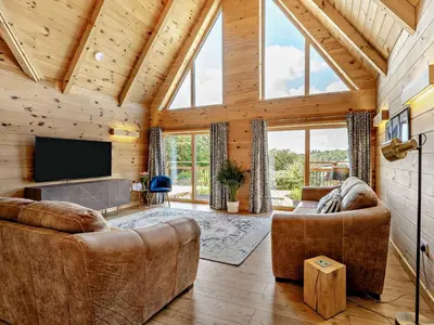 a living room with couches and a flat screen tv at 4 Bed in Kippford 95234 in Kippford