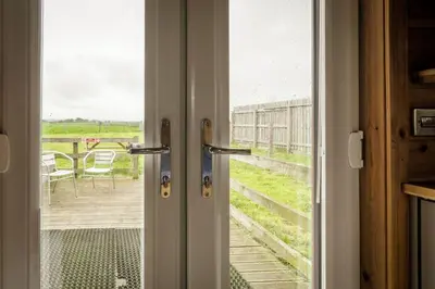 an open door with a view of a deck at Unit 2 - Carrock View Camping Pod in Carlisle