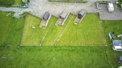 an overhead view of a group of cars on a field at Unit 2 - Carrock View Camping Pod in Carlisle