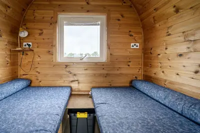 a small room with two beds and a window at Unit 4 - Skiddaw View Camping Pod in Carlisle