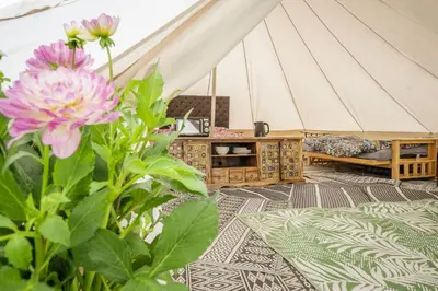 a room with a tent with a couch and a flower at Unit 1 - Dolly Daydream Bell Tent in Carlisle