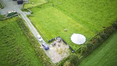 an aerial view of a field with a tent and cars at Unit 1 - Dolly Daydream Bell Tent in Carlisle