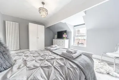 a bedroom with a large bed with towels on it at Luxury townhouse in Workington in Workington